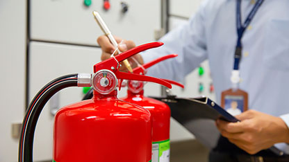 Engineer are inspection Fire extinguisher in fire control room f Engineer inspection fire extinguisher in fire control room
